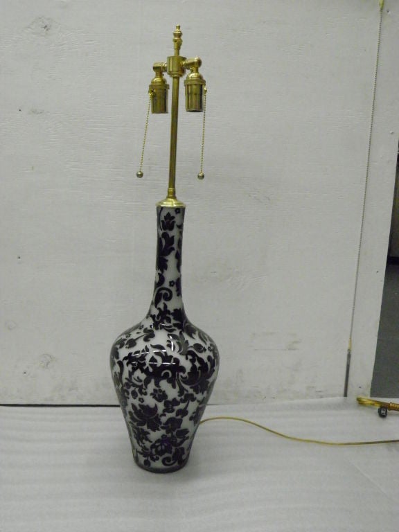 Black floral design on white glass vases with extendable post and lamp application.