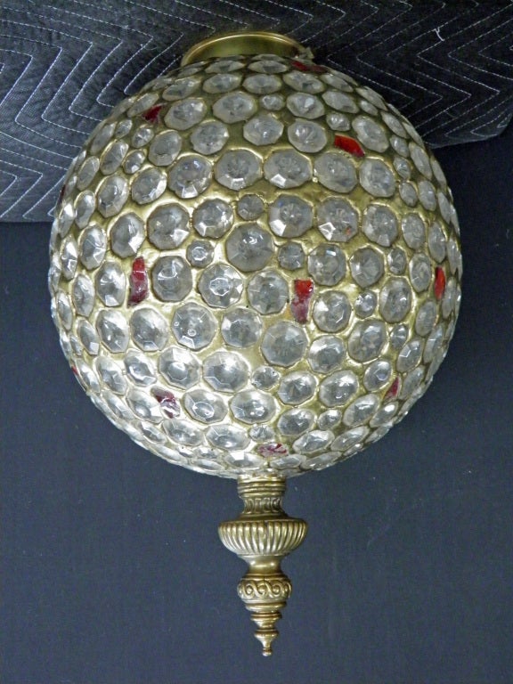 Large faceted crystal and red glass globe set in brass with a tooled detailed brass finial and mounting plate