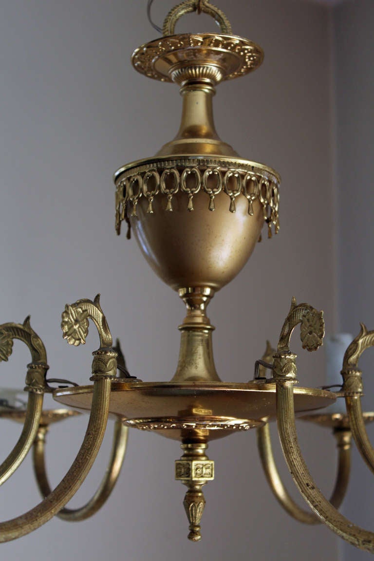 pair of French Brass plated 6 candle chandeliers with elegant detailing.  Each comes with a 14