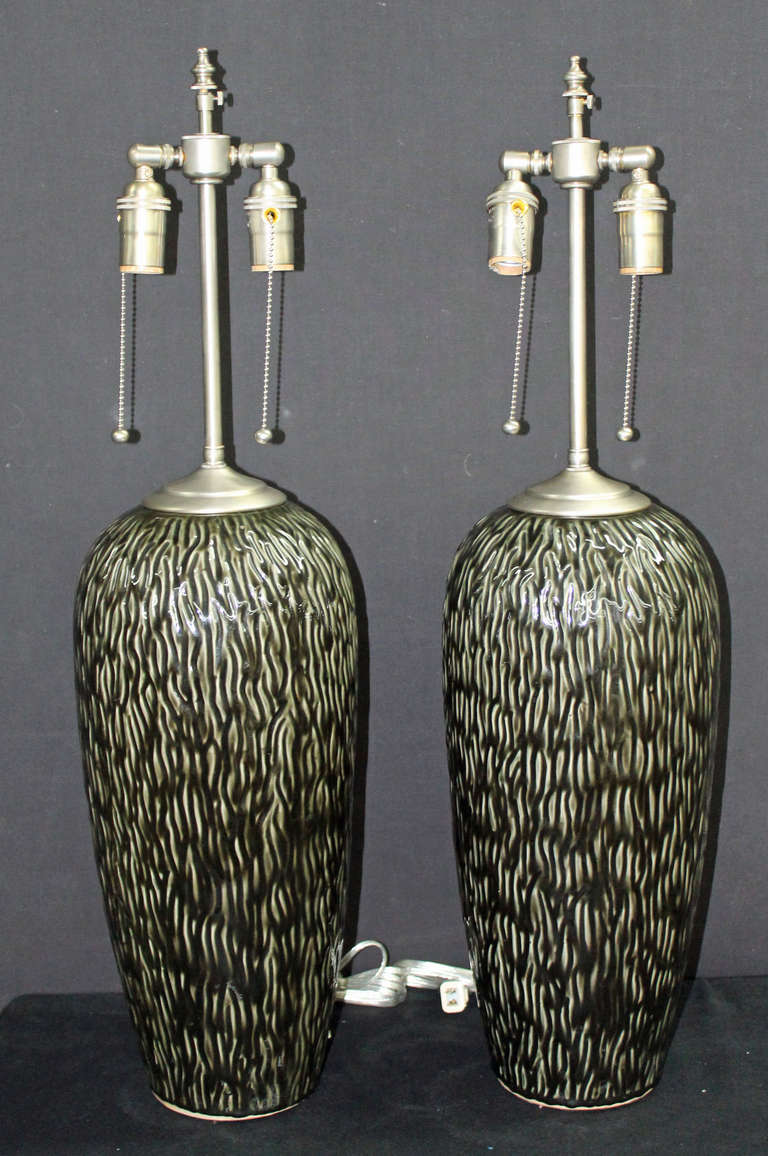 Large and unusual black and white textured ceramic vases with lamp application.  The vases measure 22