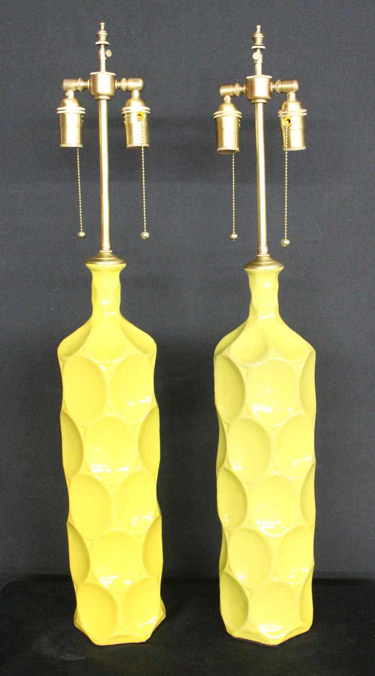 Yellow Ceramic vessels with lamp application.  Hardware is of brushed brass with dual light sockets and individual pull switch controls.    The vase is 22