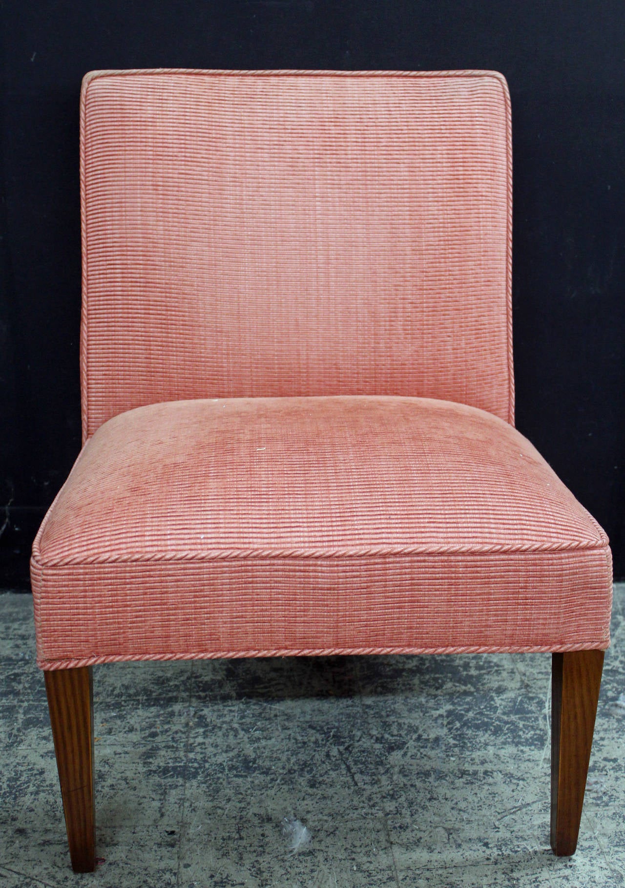 Pair of vintage side chairs in a rose corded fabric. The wood feet are finished in mahogany.