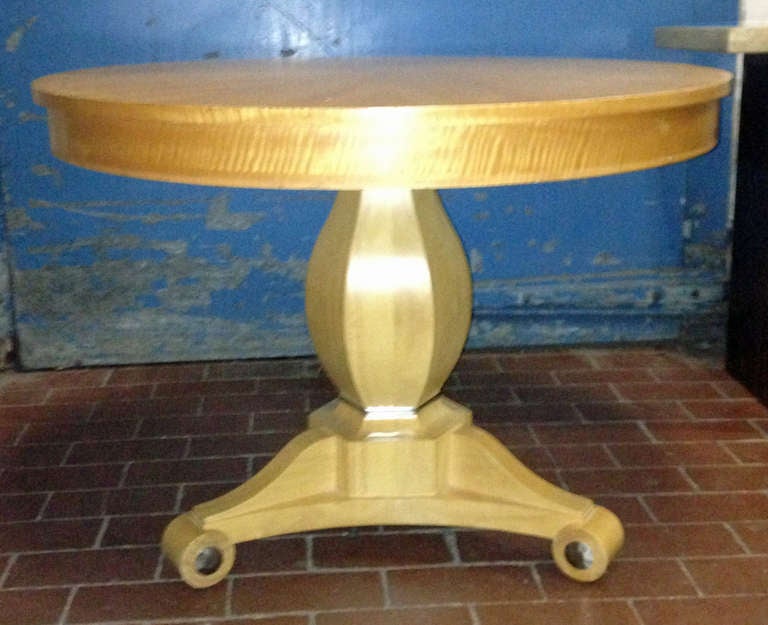 Elegantly detailed custom, tri-foot balustrade table in figured sycamore with metal inset details at base.