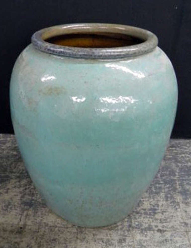 Monumental terracotta urn in a turquoise glaze.