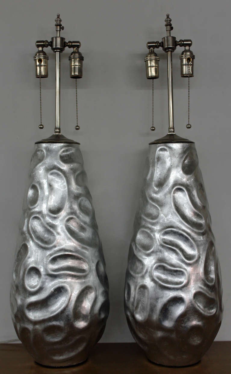Pair of large silver leafed vases with lamp application.  The brushed Nickel posts bear dual sockets with individual pull chains extends and additional 3