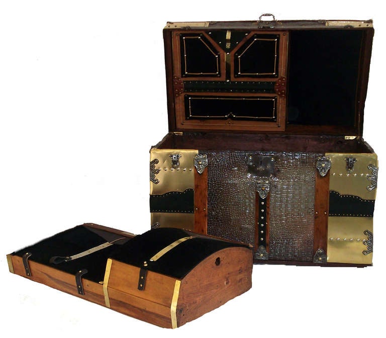 Large Saratoga Grade Camel Back Antique Trunk Circa 1880’s
Original Hardware, “Alligator” Pressed Tin Facings
Brass Sheet Binding with Black Leather Front and Top 
Leather Side Handles, Inner Drop Down Compartment
Interior lined with Black