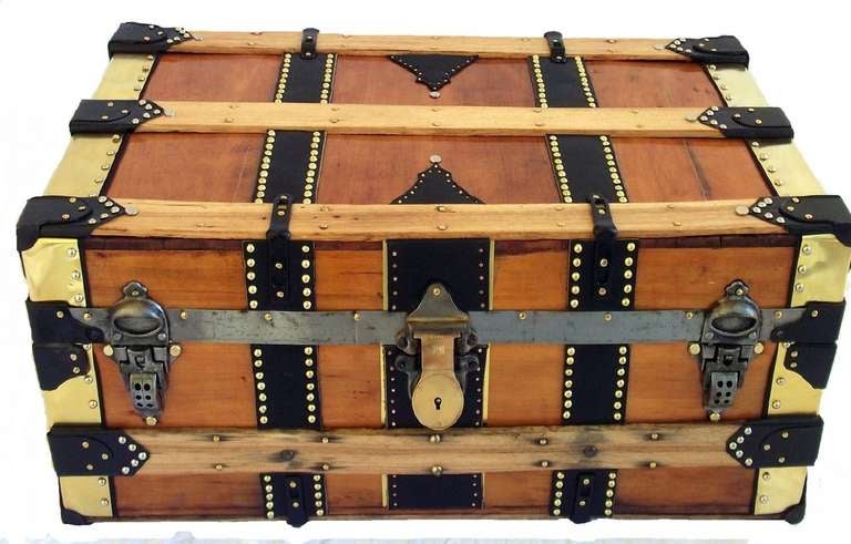 Vintage Restored Monroe Trunk
Natural Finish Cabin Trunk with 10 Coats of Low Luster Tung Oil
Original Cast Hardware, Solid Brass Lock, Hand Stitched Black Leather Handles
Brass Sheet Binding with Black Leather Center Bands
Lined in 100% Cotton
