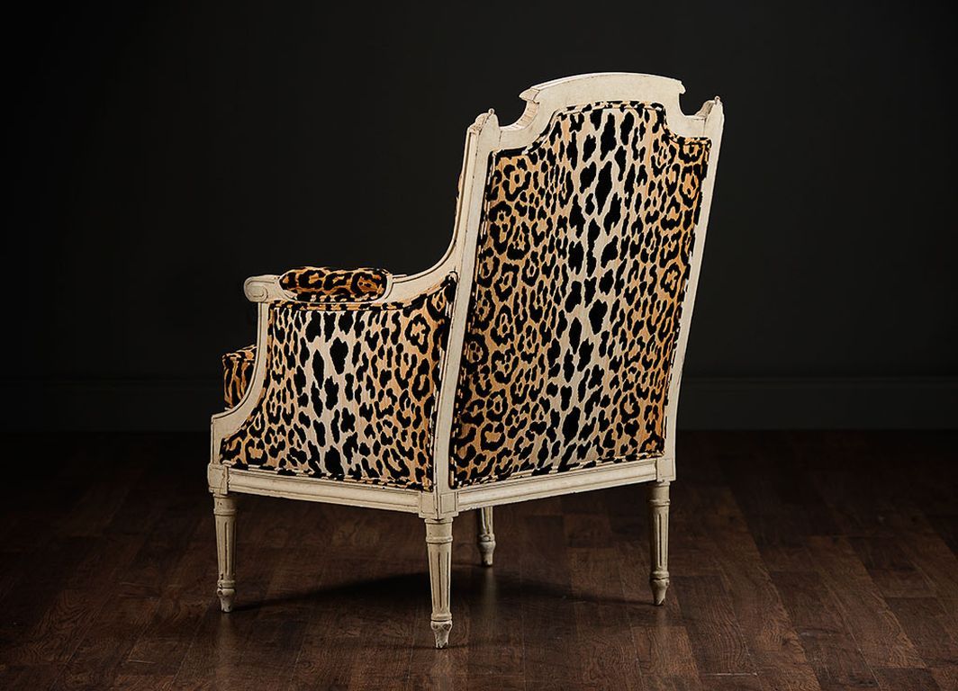 Pair of Antique French Louis XVI Style Bergeres with Leopard Print Upholstery, Down Seat and White Painted Finish