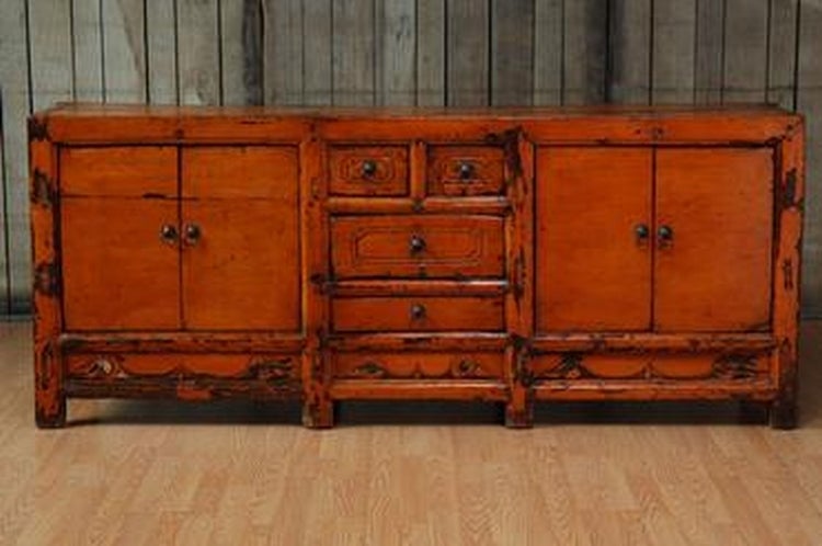 Unusual Antique Chinese Buffet with Orange/Reddish Painted Surface, Four Center Drawers (Two Small Top Drawers and Two Longer Center Drawers) and Two Pair of Doors on Either End with Carved Details in Frame Poplar Wood Buffet
Gansu Provence