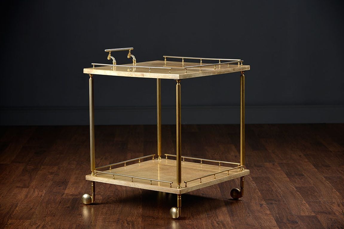 Vintage French Bar Cart with Brass Frame, Legs, Rail Surround
and Casters and Lacquered Parchment Tops