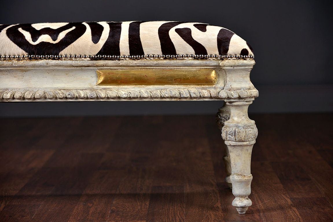 Antique Spanish Carved Bench
Painted in Aged Swedish Grey with Gilded Accents
Zebra Cowhide with Nickel Nail Trim