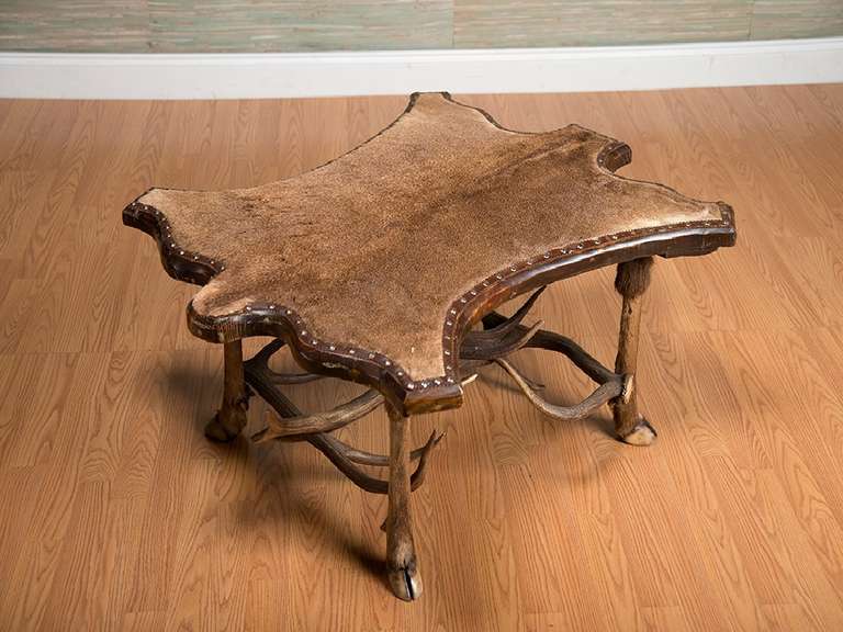 Vintage Fur-Covered Coffee Table with Antler Cross Stretchers and Hoofed Legs, Table Top is in The Pattern of the Skin, With Nail Head Décor