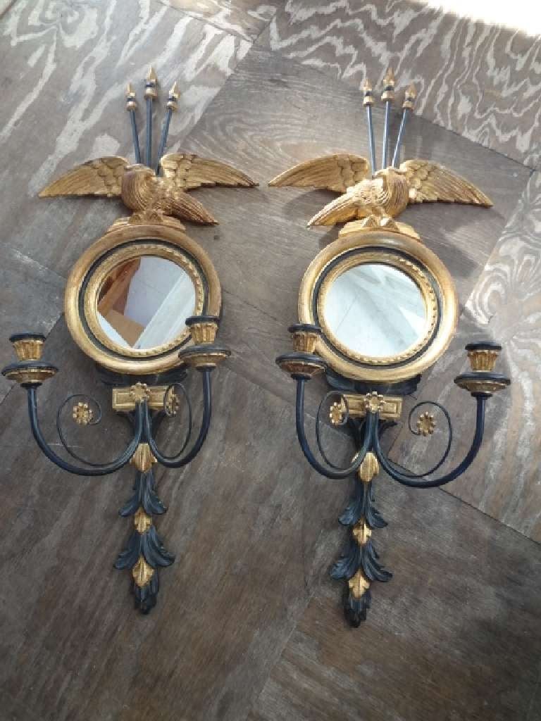 Vintage pair of Italian gold and black wood 2 light eagle and round mirror sconces.