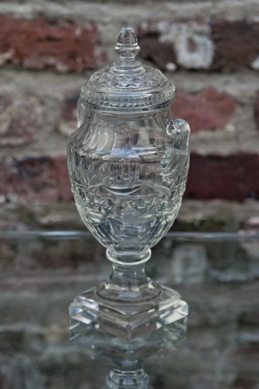 Pair of 19th century cut crystal Anglo-Irish sweetmeat jars in urn form on square bases. Excellent condition.