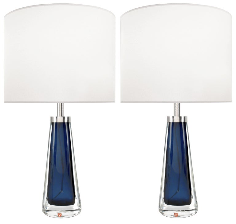A pair of blue glass lamps with thick clear glass casing with polished nickel hardware by Nils Landberg for Orrefors.

Swedish,  Circa 1950's

Lamp Shades Are Not Included.

If you are interested in Lamp Shades, please email The Craig Van Den Brulle