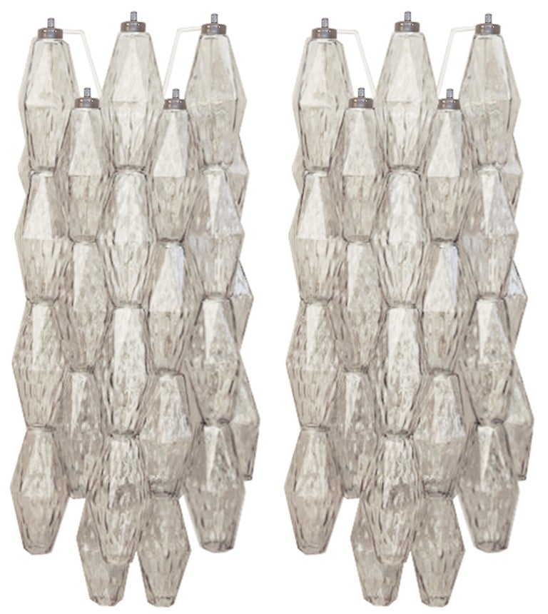 A pair of sconces with polyhedral shaped glass in smoky gray on a white painted metal frame with nickel hardware by Venini.

Italian, Circa 1960's
 