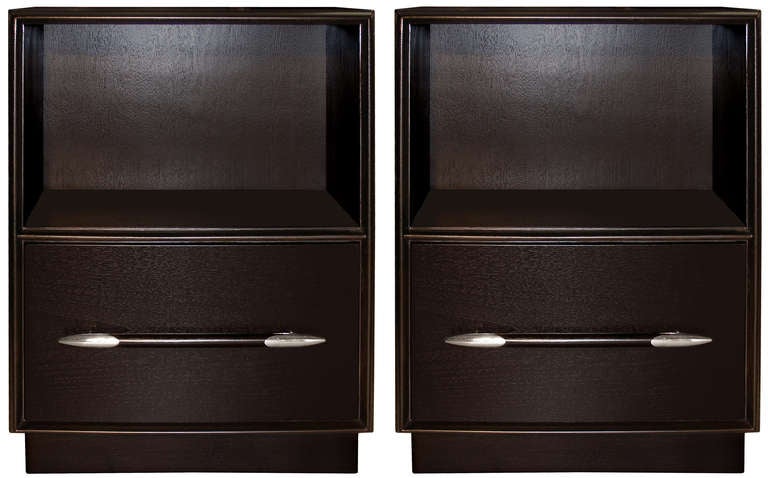 An ebonized walnut dresser / server with three drawers and two doors and nickel detail on pulls by T.H. Robsjohn-Gibbings. American C. 1940's - Dresser and side tables are the same color and finish.