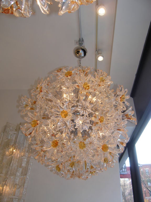 An esprit amber and clear glass flower chandelier with chrome frame and hardware by Venini.

Italian, Circa 1970's

Two (2) Chandeliers Available.