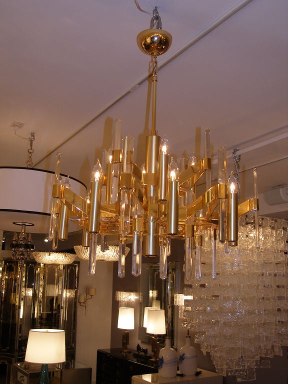 A gilt brass chandelier with 12 lights and faceted glass by Sciolari, Italian C. 1970's