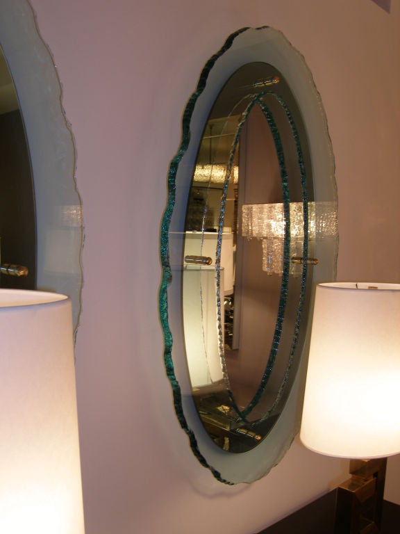 An oval mirror with oval glass with chipped edges framing the mirror.

Italy, Circa 1970's

In stock.