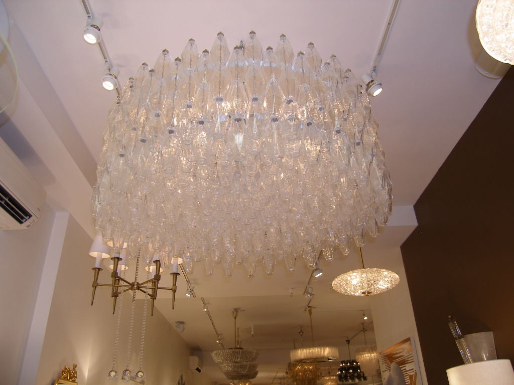 A large round clear glass polyhedral chandelier on a white metal frame by Venini.

Italian, Circa 1970's