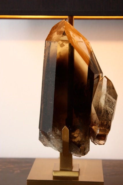 A large smoky rock crystal lamp mounted on a fitted bronze base by Willy Daro, Belgium C. 1970's