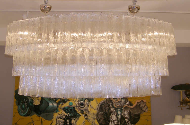 A large chandelier consisting of multiple textured clear glass tubes hanging on a metal frame with polished nickel hardware.

Italian, late 20th century

Special Order.

Lead Time: 14-16 Weeks.