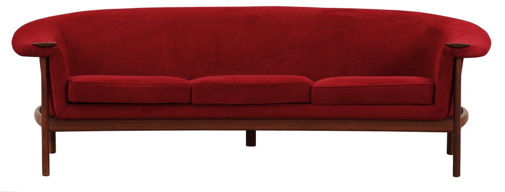An upholstered curved sofa with solid walnut frame and armrests.

In stock.

Fabric: Short-Cut Cotton Velvet

Color: Garnet Red/Cooler Red-Midtone

Seat Cushions: Reversible - fabric on both sides

Seat Cushion: Dacron/ Medium-Firm Foam

Purchased
