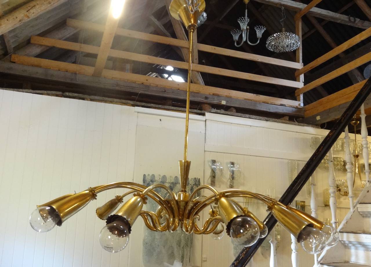 A large brass ceiling fixture with multiple curvaceous arms by Oscar Torlasco.

Italian, circa 1950s.