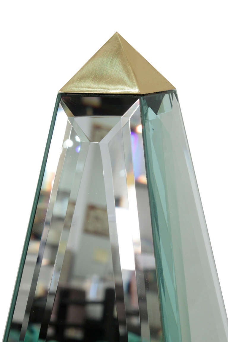 Pair of large obelisks with beveled mirrored panels and brass accents, American, 1970s.