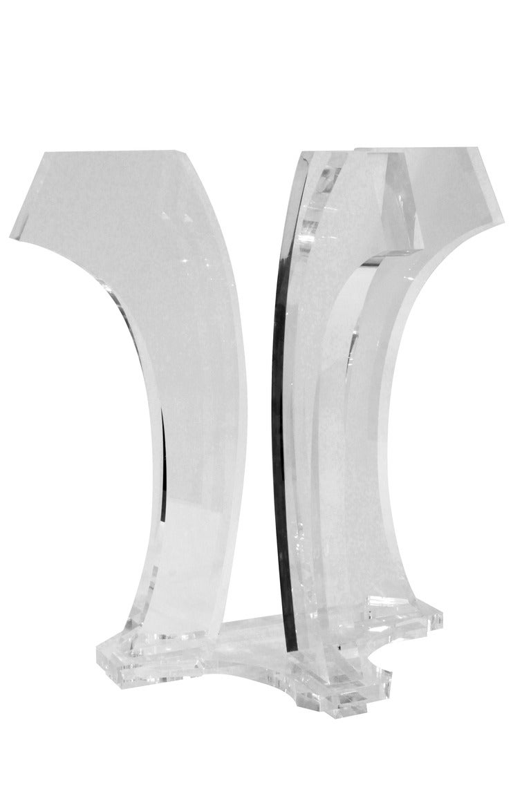 Dining table with thick sculptural lucite bases and glass top by Jeffrey Bigelow, American 1978 (signed and dated (Jeffrey Bigelow 78).
This table can support a glass top of any size.