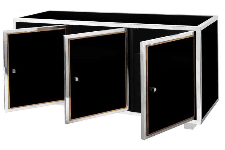 Exceptional sideboard in black glass with steel and brass trim and lucite block legs by Guy Lefevre for Maison Jansen, France 1970's.  This sideboard is beautifully crafted.