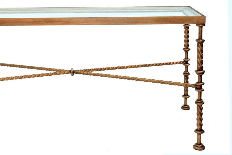 Coffee table in gilded bronze with hand-turned stretchers and legs with inset glass top, American, 1970s.