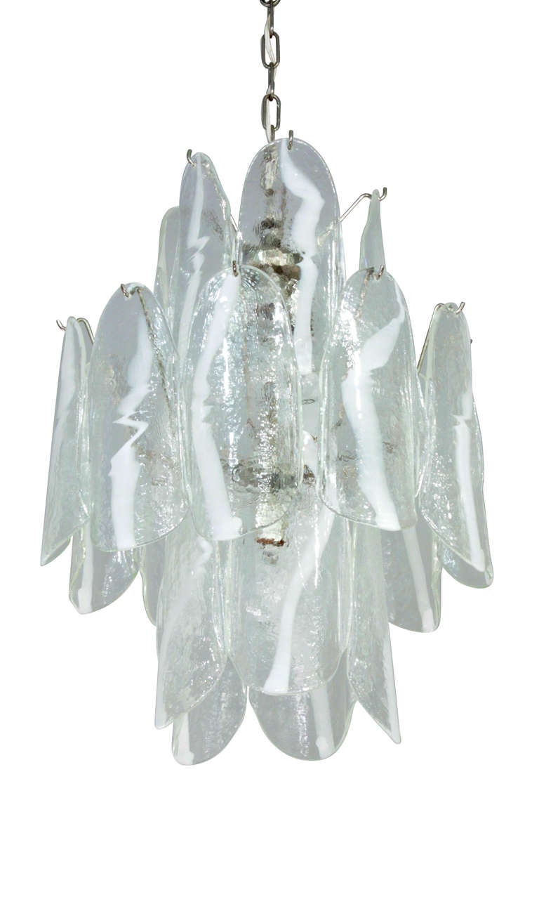 Large chandelier with molded glass panels, each one clear with white stripe (fasce) decoration, by Mazzega, Murano, Italy, 1950s.
Height is for the glass portion only.  Overall height can be customized with a rod or chain.