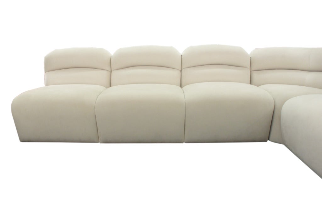 Sectional sofa upholstered in ultrasuede by Brueton Industries, 
American 1970's

Each side of the sofa measures 118 inches long including the corner.  The pieces can be moved individually to make one side larger than the other.  They bolt into