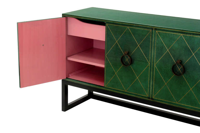 4 Door credenza TP18 in hand-tooled leather with brass knockers and 
dark mahogany base by Tommi Parzinger for Charak Modern, American 1940's.
Retains original pink lacquered interior.