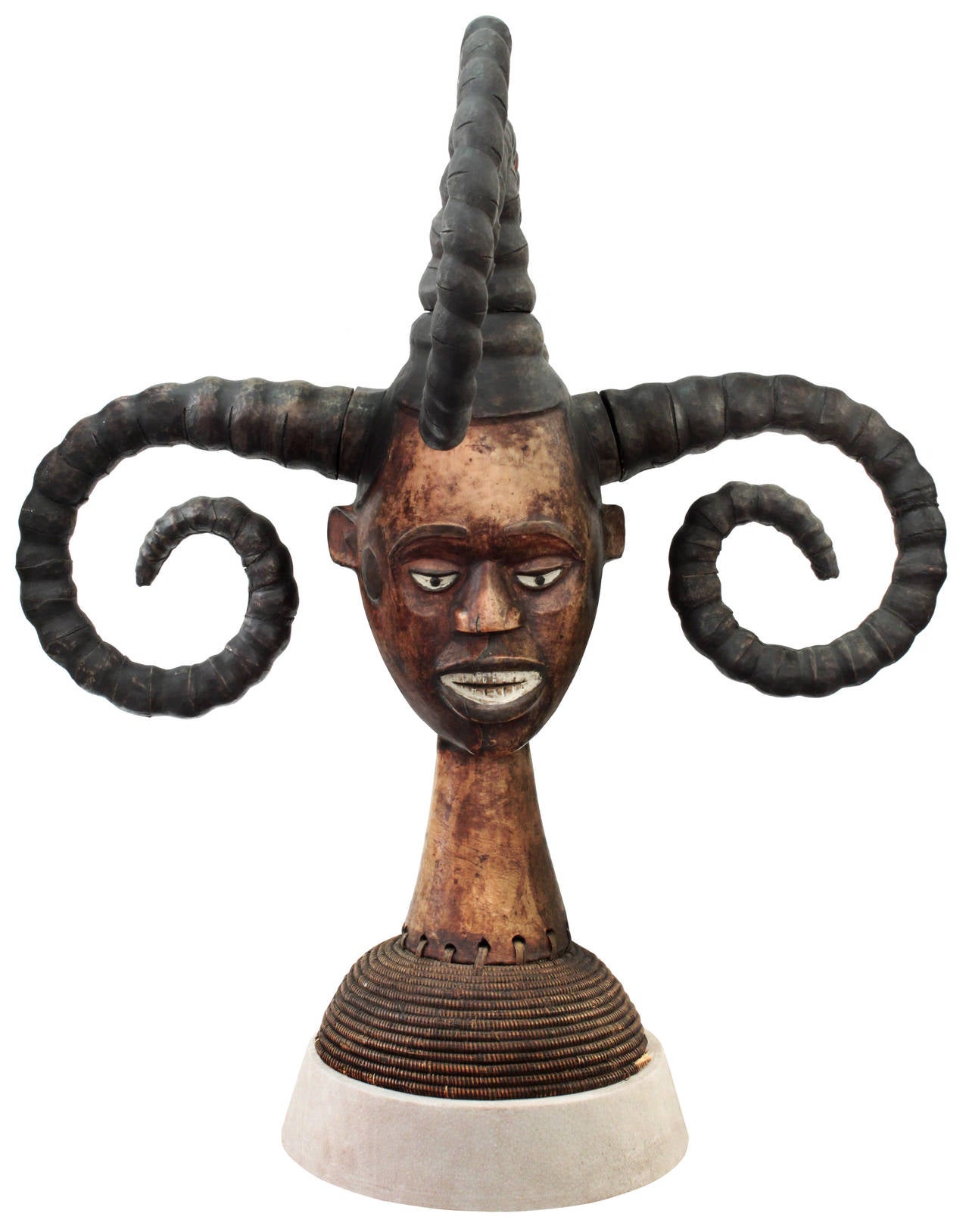 Authentic hand-carved African sculpture, woman's head with four horns, by the Ekoi tribe in Nigeria with a suede base by Karl Springer, American, 1980's
(photo of original Karl Springer tag included). The horns are representations of ethnic hair