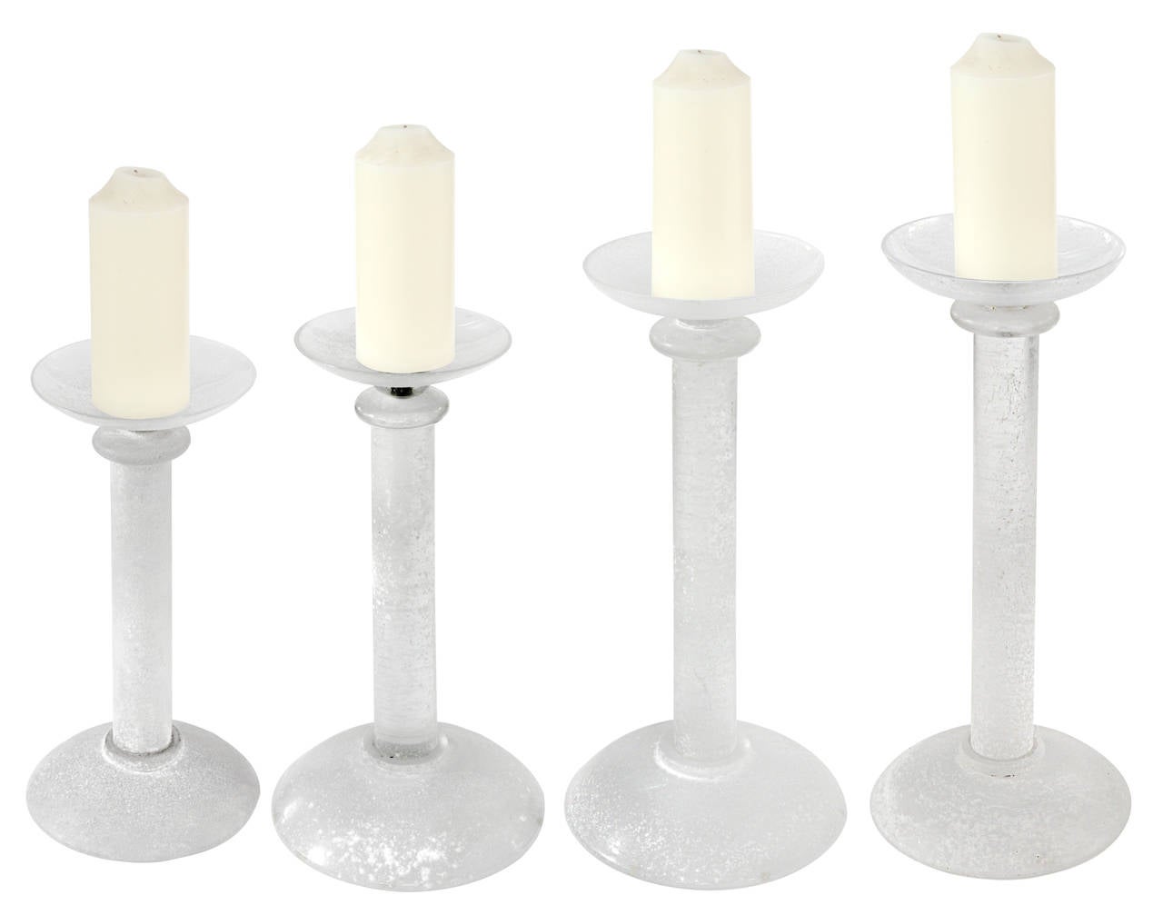 Set of four candleholders in white glass with scavo (rough) finish by Seguso (Murano, Italy) for Karl Springer, American, 1980s.
Signed on bottom “Karl Springer”.
Dimensions:
Smallest candleholder:
14 inches high
8 1/2 inch diameter

Medium