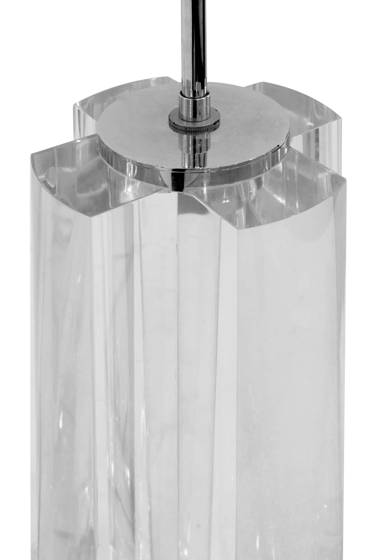 Sculptural Lucite block table lamp with polished stainless steel base and
accents in the manner of Karl Springer, American, 1980s. This lamp is beautifully made.