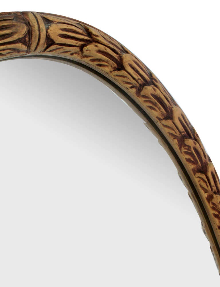Wall-hanging mirror with carved and gilded frame, American, 1950s.