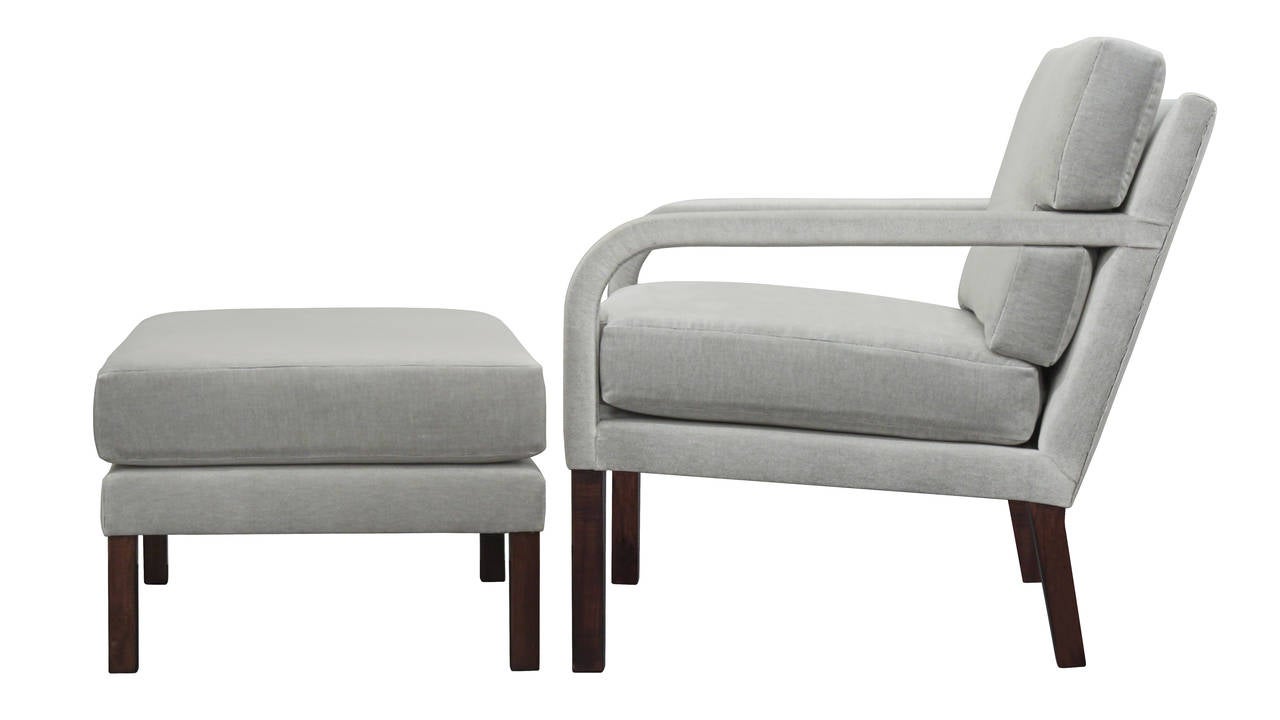 Elegant chair and ottoman with upholstered arms and walnut legs by Directional Furniture, American, 1960s.
Newly reupholstered in gray velvet by Lobel Modern. 
This is a very chic design.

The ottoman is 26 inches wide x 20 1/2 inches deep x 16