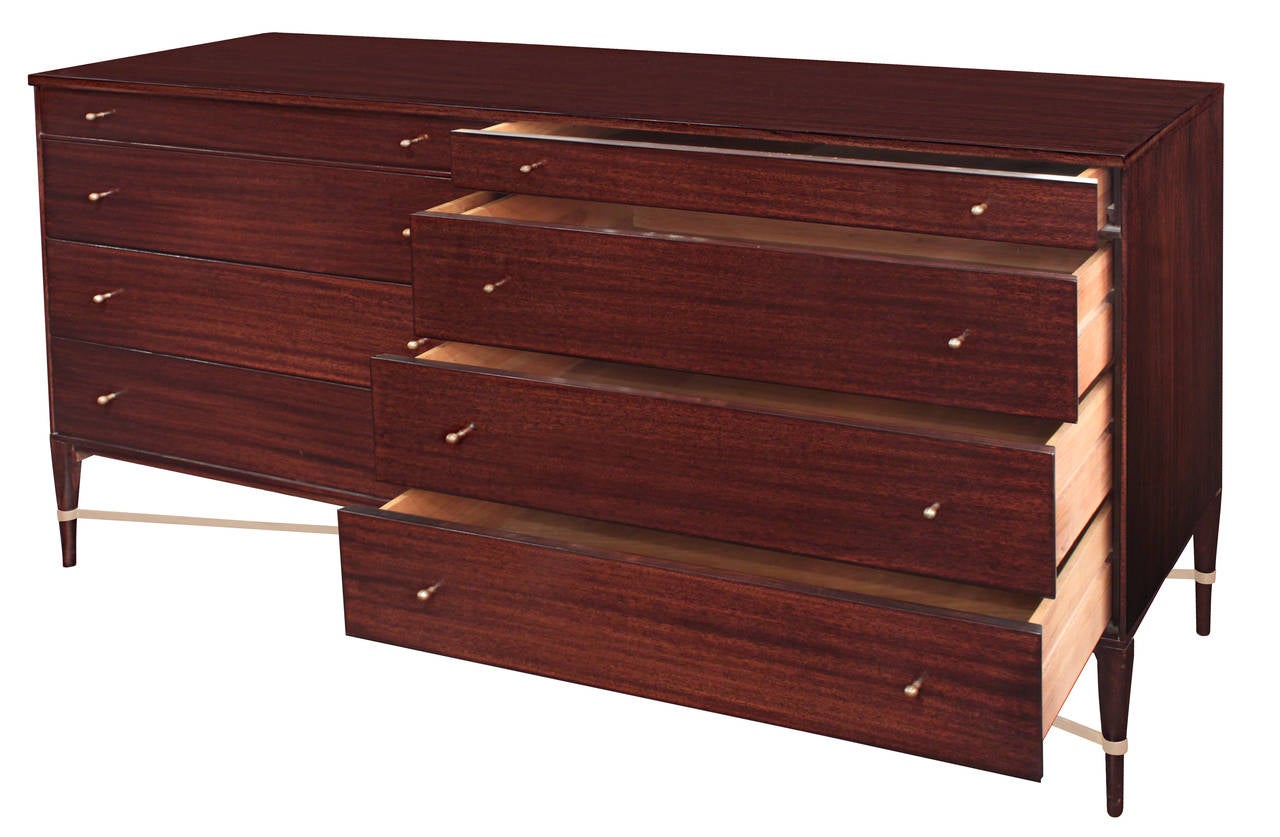 Chest of drawers model No. 1006 in mahogany with brass pulls and X stretcher between legs by Paul McCobb for Calvin Furniture, American 1950’s (signed “The Calvin Group designed by Paul McCobb” on inside top left drawer)
