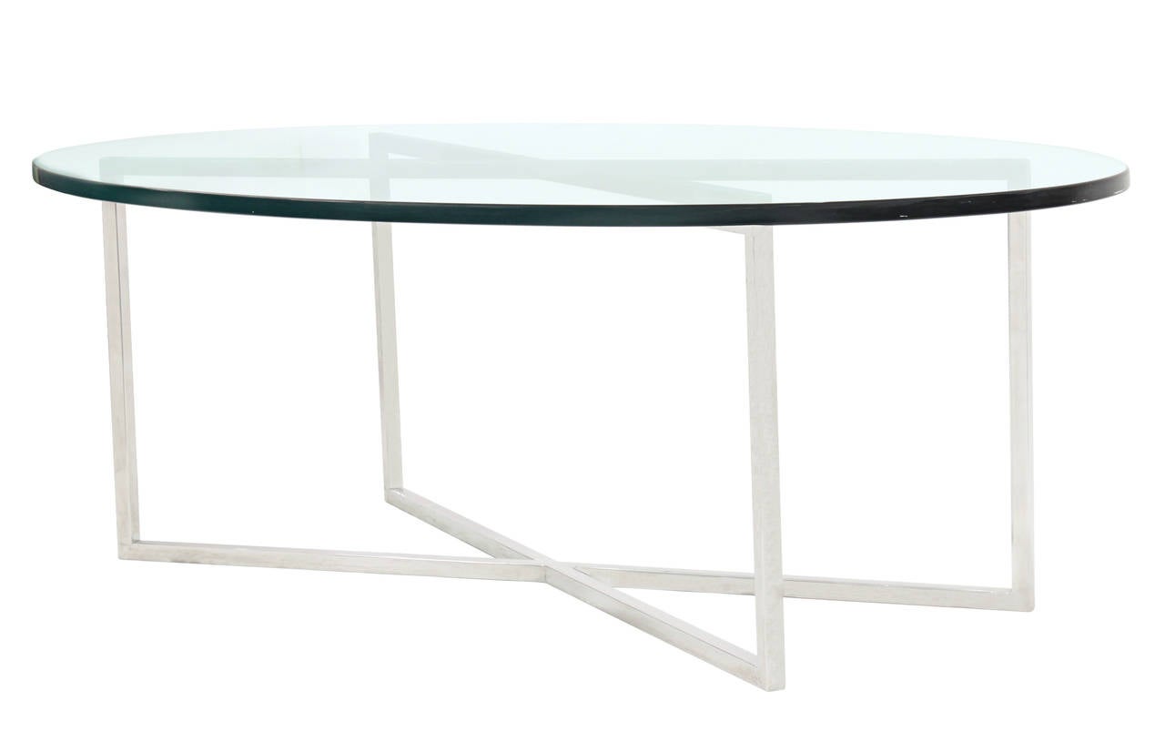 Elegant coffee table with polished steel base and oval glass top by Tommi Parzinger for Parzinger Originals, American, 1960s.