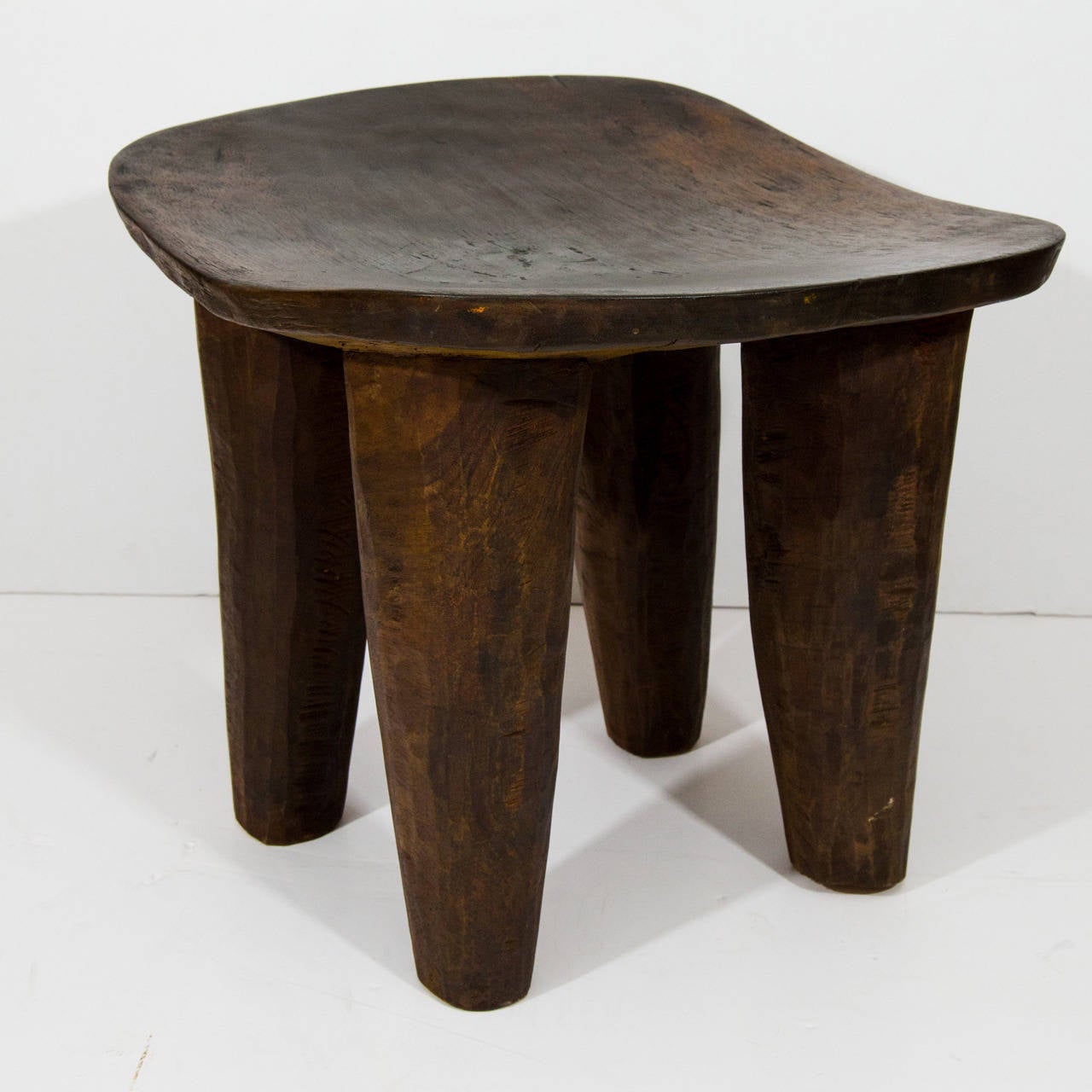 Hand-carved stools made from one solid piece of wood.