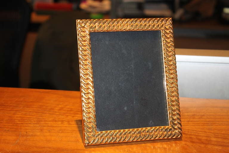 The gold link chain design is really rare to find. The frame is super quality and the back is all leather.