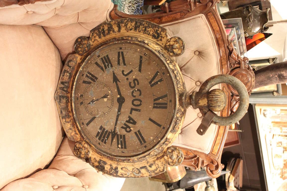 This is a wonderful as found  figural trade sign. The sign is 2 sided with the same image on both sides. The clock is made of zinc and then was hand painted for a jeweler named J. Scolar. The outer section of the clock is gilt metal and reads