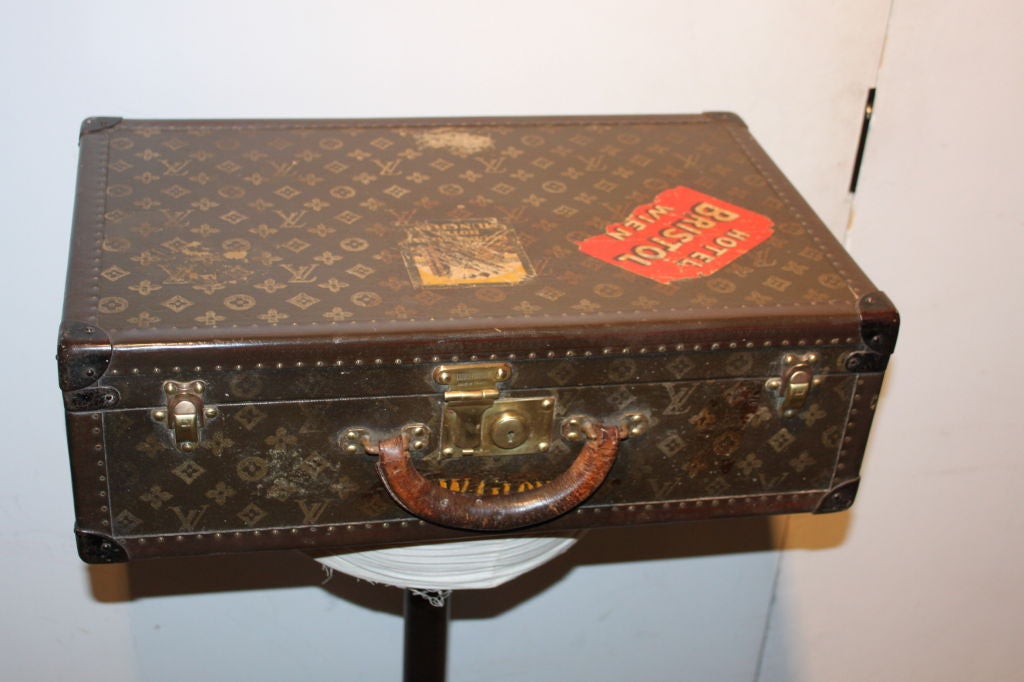 Beautiful, rich LV suitcase with original travel stickers.