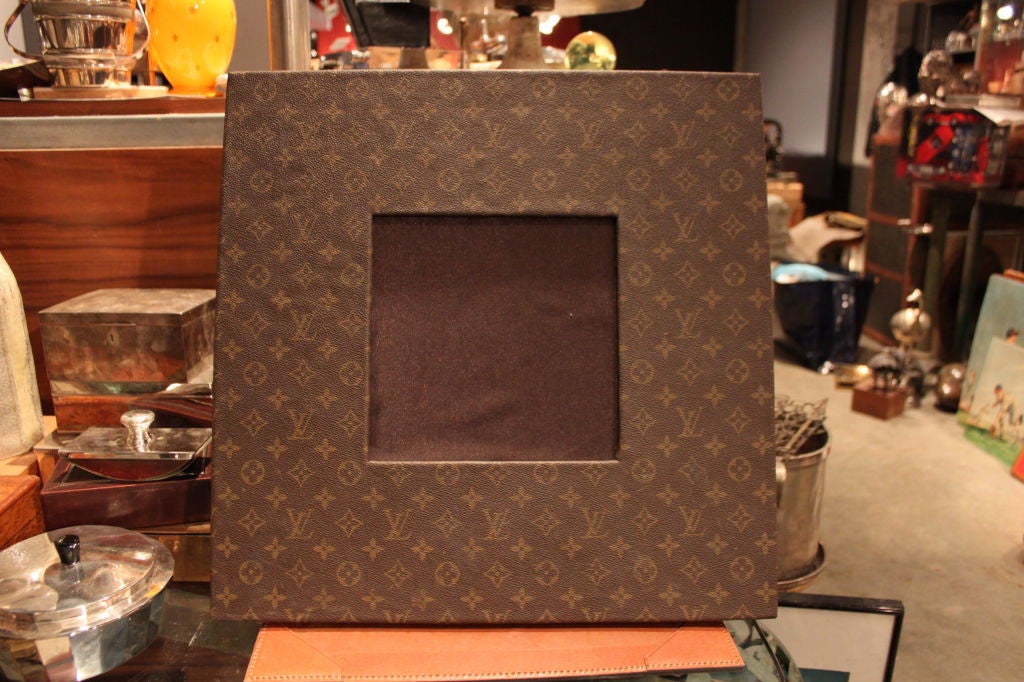This is a giant custom ordered frame by Louis Vuitton. It was manufactured in the 1970's. It can obviously be used as a tabletop mirror as well.