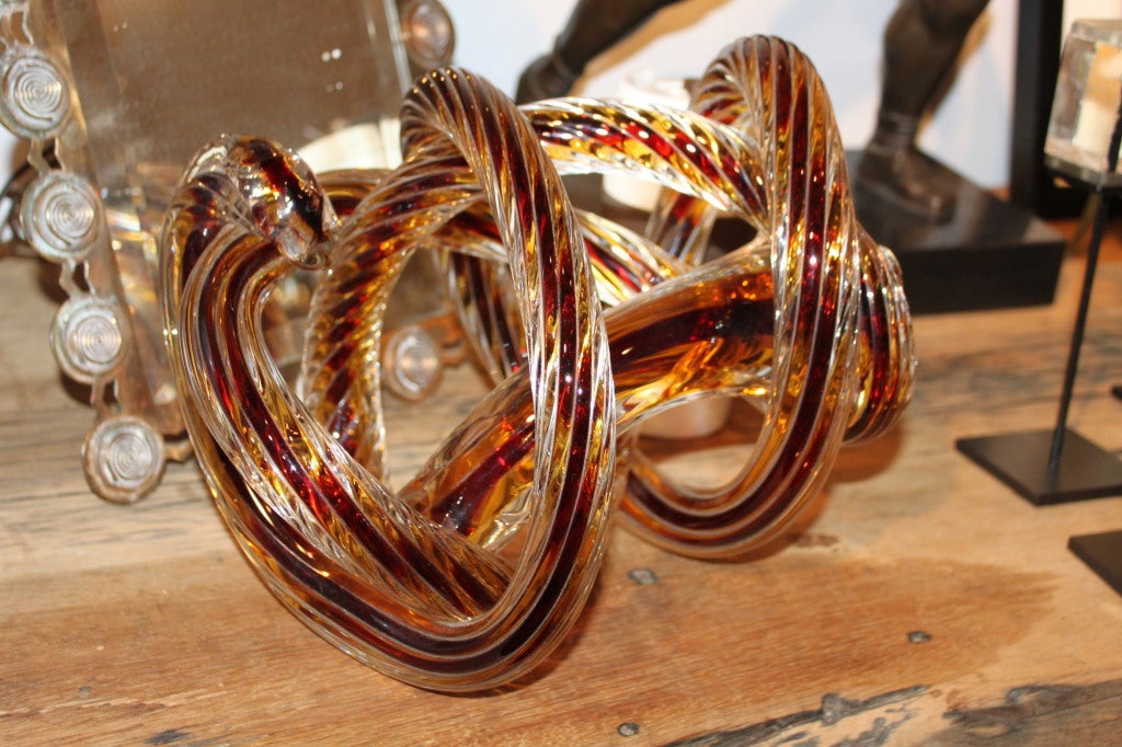 This is a very unusual and probably quite difficult to make. The glass is actually twisted as well as knotted.