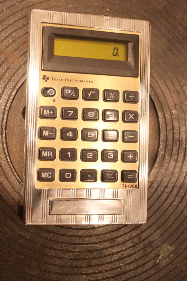 This is as chic as it gets. This is a working Texas instruments calculator encased in a sterling cover made by Cartier.The case is signed Cartier and sterling.The calculator works perfectly.